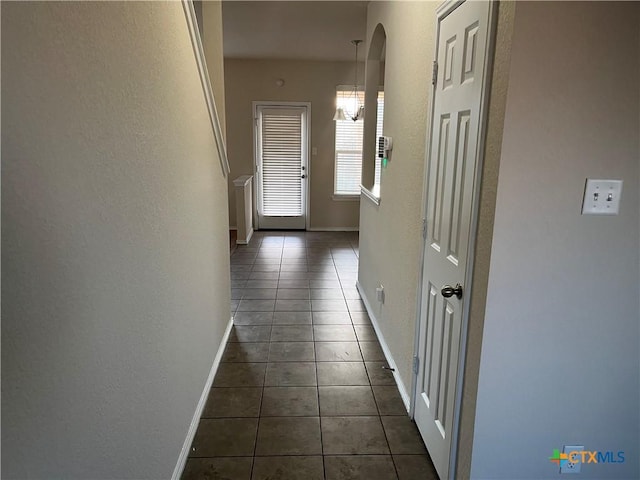 hall with dark tile patterned flooring