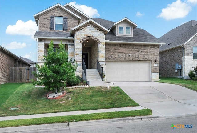 view of front of house featuring a garage and a front lawn