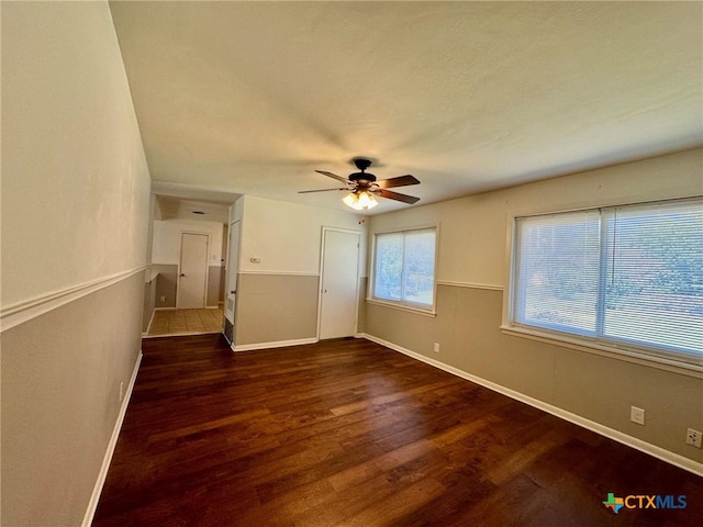 unfurnished bedroom with dark hardwood / wood-style flooring and ceiling fan