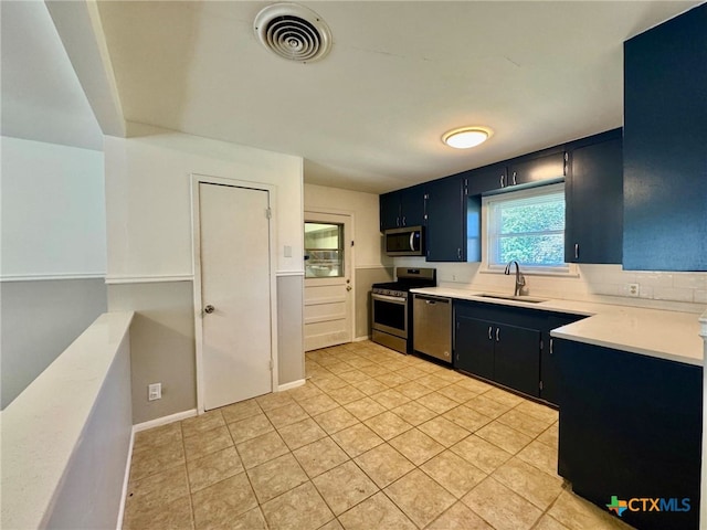 kitchen featuring appliances with stainless steel finishes, sink, and light tile patterned floors