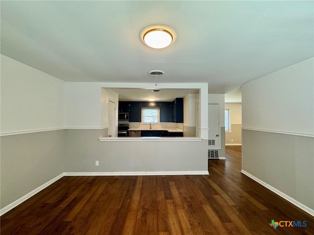 interior space with dark hardwood / wood-style flooring and sink