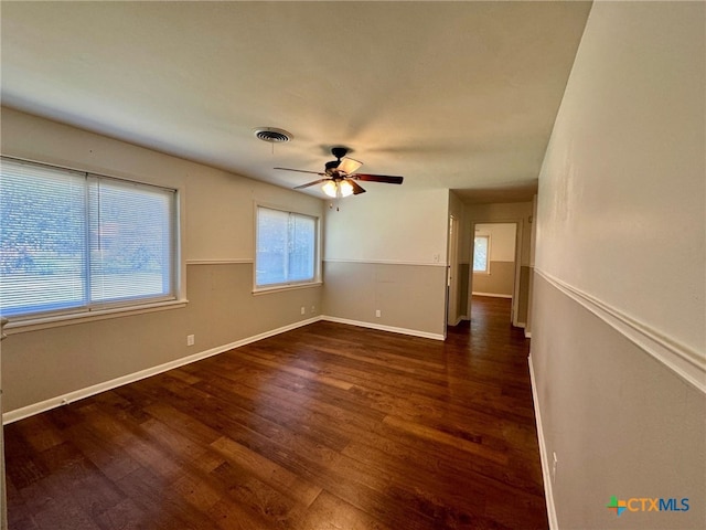 unfurnished room with dark hardwood / wood-style flooring and ceiling fan