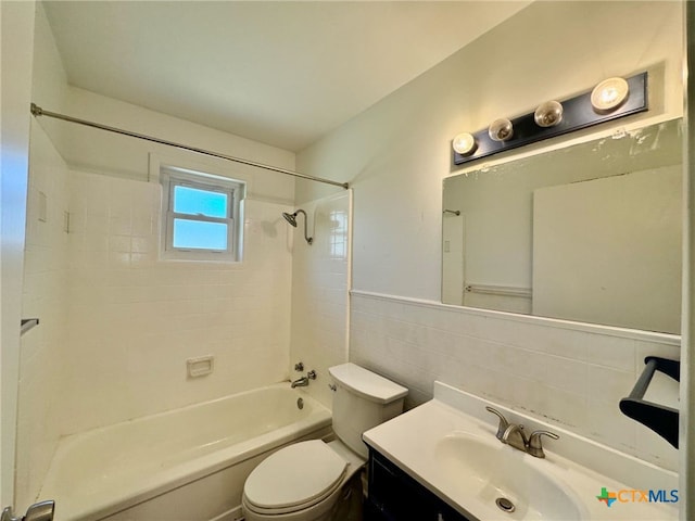 full bathroom featuring tile walls, vanity, tiled shower / bath combo, and toilet