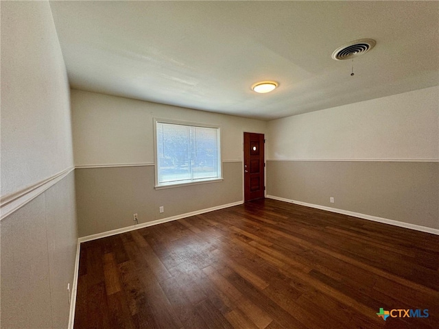 spare room featuring dark hardwood / wood-style floors