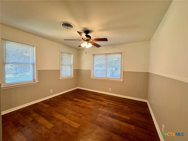 spare room featuring ceiling fan and dark hardwood / wood-style flooring