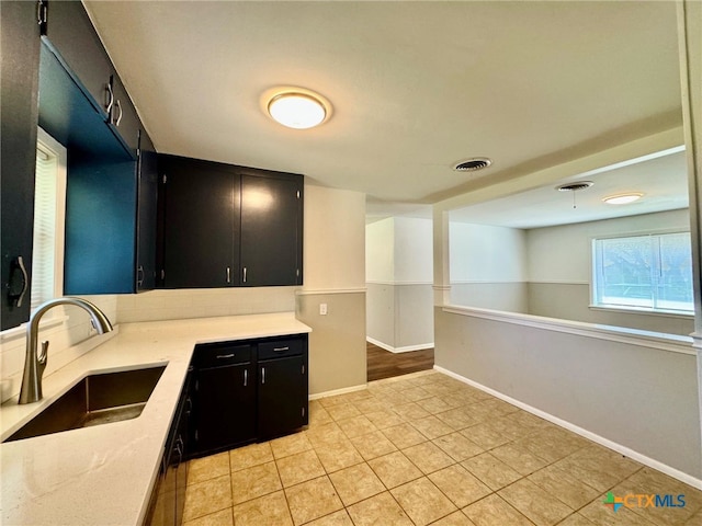 kitchen with sink and light tile patterned flooring