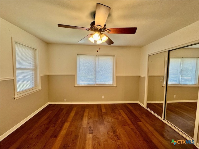 unfurnished room with a textured ceiling, dark hardwood / wood-style floors, and ceiling fan