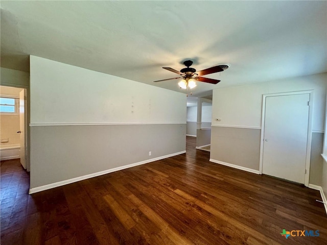 spare room featuring ceiling fan and dark hardwood / wood-style floors