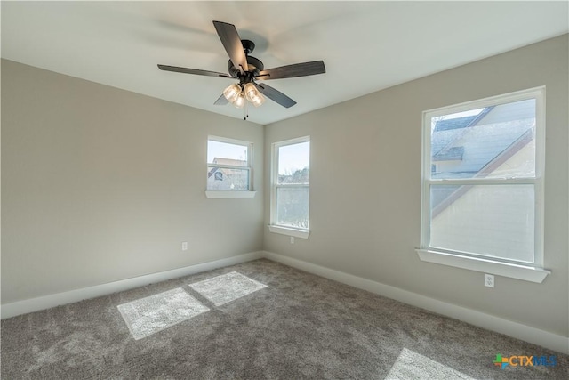 carpeted empty room featuring ceiling fan