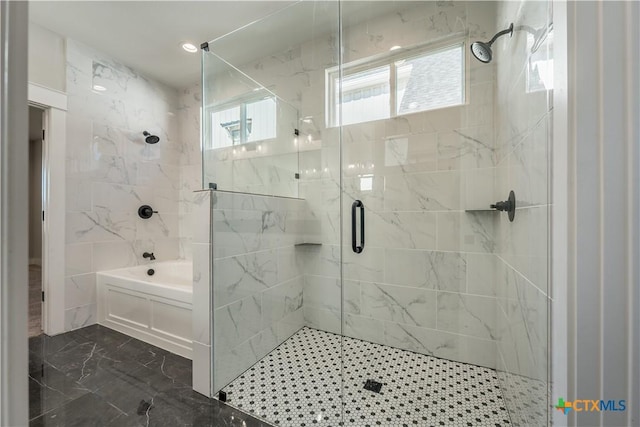 bathroom featuring independent shower and bath