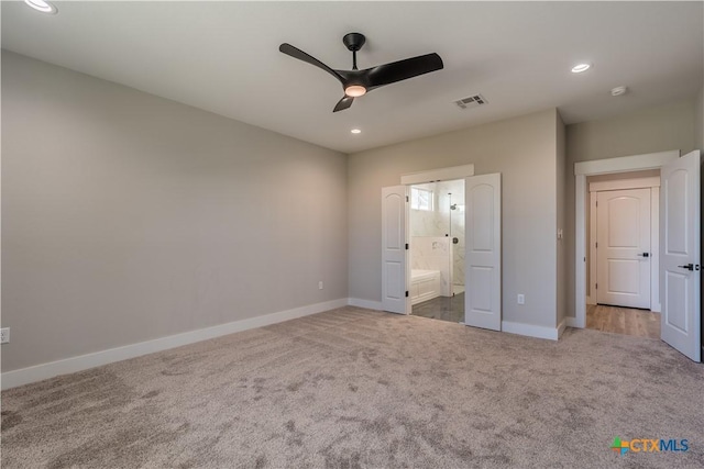 unfurnished bedroom with ceiling fan, ensuite bathroom, and carpet