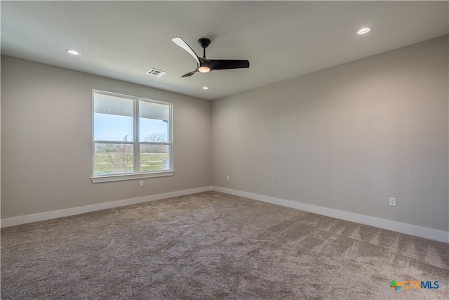 spare room featuring ceiling fan and carpet flooring