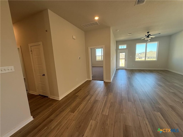 empty room with ceiling fan and dark hardwood / wood-style floors