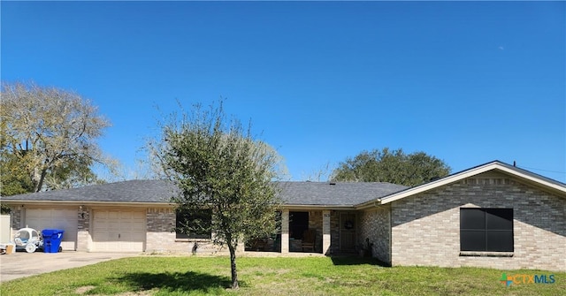 ranch-style house with a front yard, concrete driveway, and brick siding