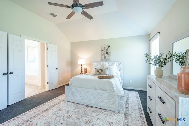 carpeted bedroom featuring ensuite bathroom, lofted ceiling, and ceiling fan