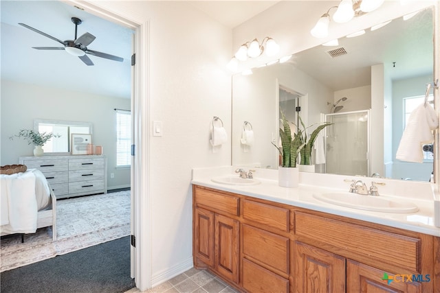 bathroom with vanity, ceiling fan, and a shower with shower door