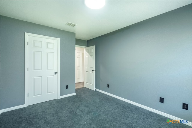 unfurnished bedroom featuring dark carpet