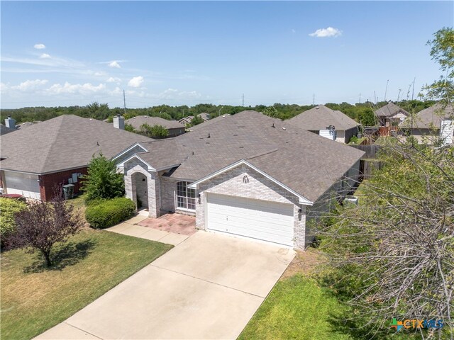 single story home featuring a garage and a front yard