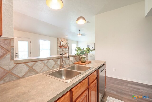 kitchen with dark wood-type flooring, pendant lighting, sink, dishwasher, and ceiling fan