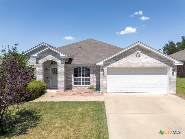 ranch-style home featuring a garage and a front yard