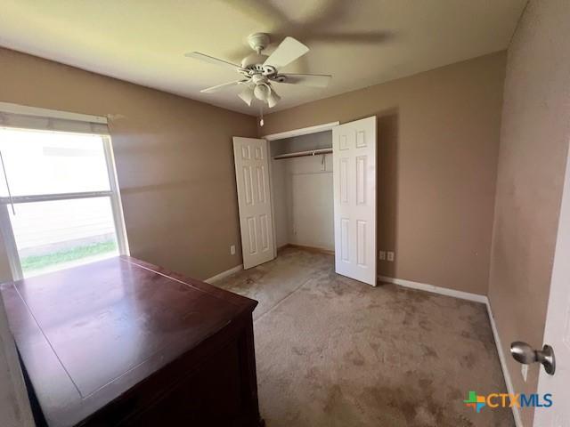 10234 Condor Loop, Waco, TX 76708 - unfurnished bedroom with a closet, light colored carpet, and a ceiling fan