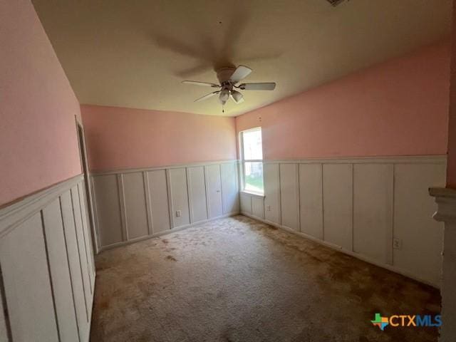 10234 Condor Loop, Waco, TX 76708 - empty room with a decorative wall, a ceiling fan, a wainscoted wall, and carpet floors