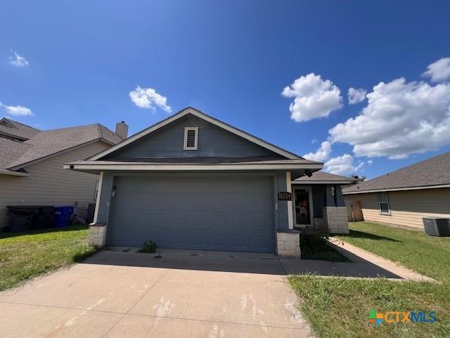 10234 Condor Loop, Waco, TX 76708 - ranch-style home with driveway, a garage, and a front lawn