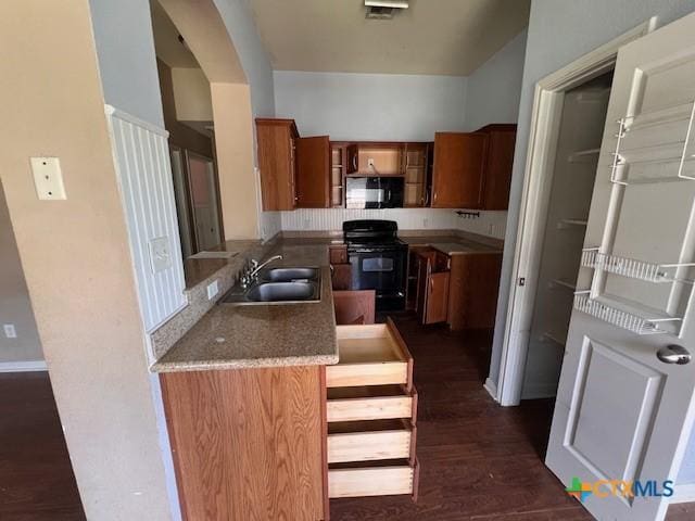 10234 Condor Loop, Waco, TX 76708 - kitchen featuring black appliances, brown cabinets, and dark wood-style flooring
