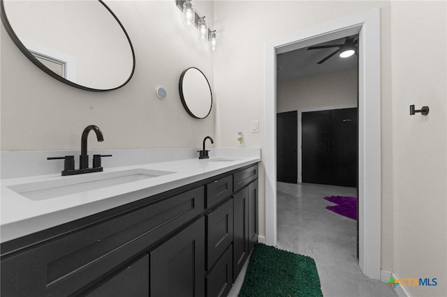 full bath with concrete floors, a sink, and double vanity