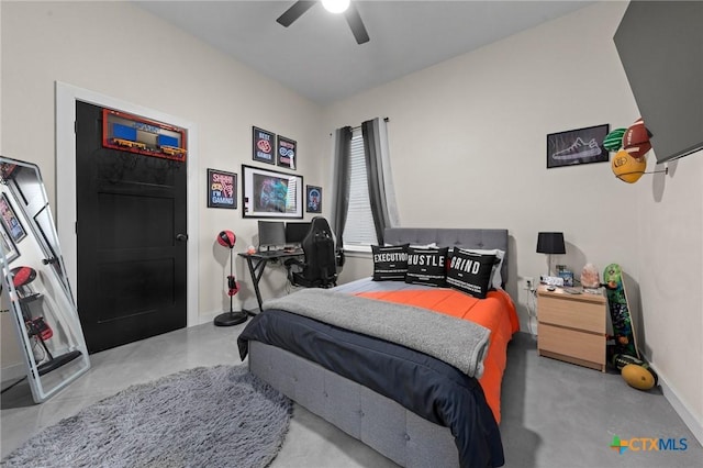 bedroom featuring concrete flooring, baseboards, and a ceiling fan