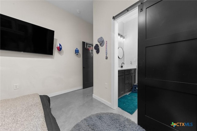 bathroom with baseboards, concrete flooring, and vanity