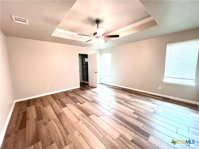 8302 Ridge Crest Dr, Killeen, TX 76542 - spare room featuring a tray ceiling, wood finished floors, baseboards, and a ceiling fan