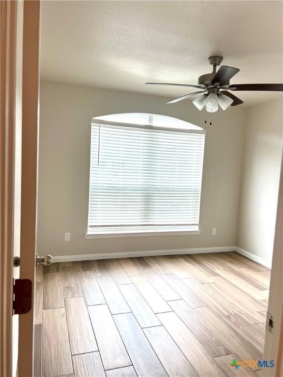 8302 Ridge Crest Dr, Killeen, TX 76542 - empty room with a ceiling fan, baseboards, wood finished floors, and plenty of natural light