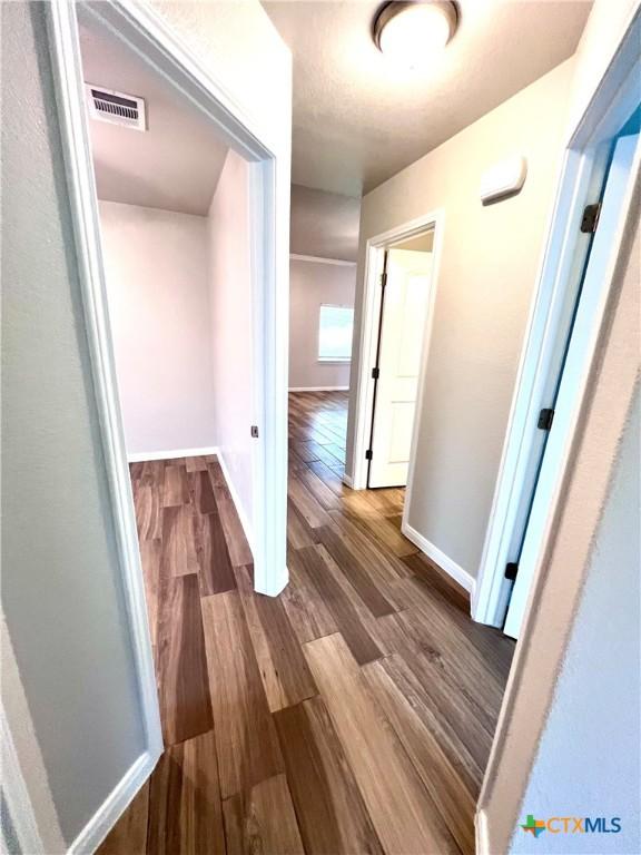 8302 Ridge Crest Dr, Killeen, TX 76542 - hallway with wood finished floors and baseboards