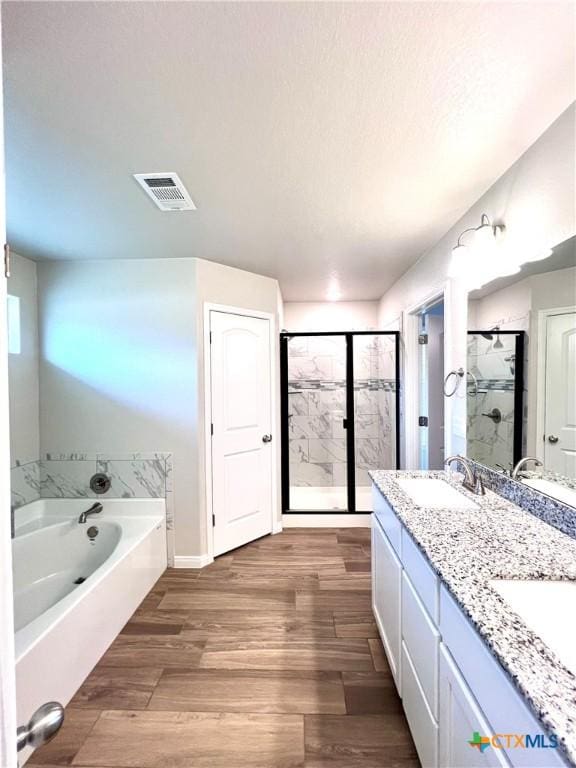 8302 Ridge Crest Dr, Killeen, TX 76542 - full bathroom featuring a garden tub, a stall shower, double vanity, and wood finished floors