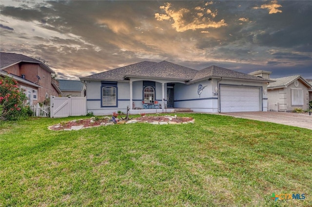 view of front of house featuring a garage and a yard