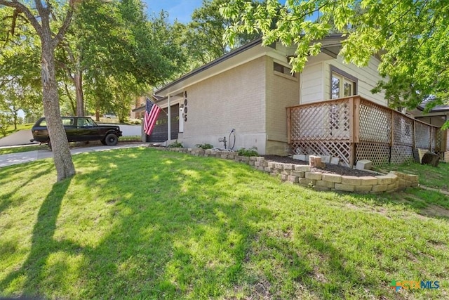 4005 Trailwood Dr, Temple, TX 76502 - view of side of home with a lawn, brick siding, and a garage