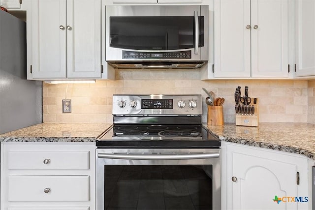 4005 Trailwood Dr, Temple, TX 76502 - kitchen featuring stainless steel appliances, white cabinetry, light stone counters, and tasteful backsplash
