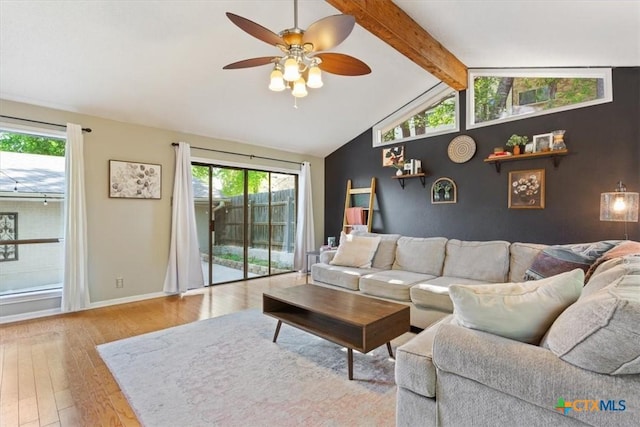 4005 Trailwood Dr, Temple, TX 76502 - living area featuring wood finished floors, a healthy amount of sunlight, a ceiling fan, and lofted ceiling with beams