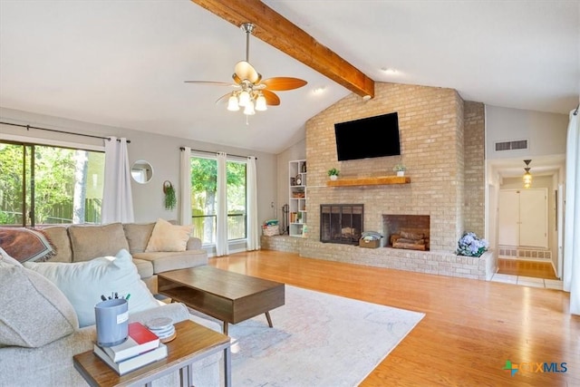 4005 Trailwood Dr, Temple, TX 76502 - living area featuring beam ceiling, visible vents, wood finished floors, a brick fireplace, and ceiling fan