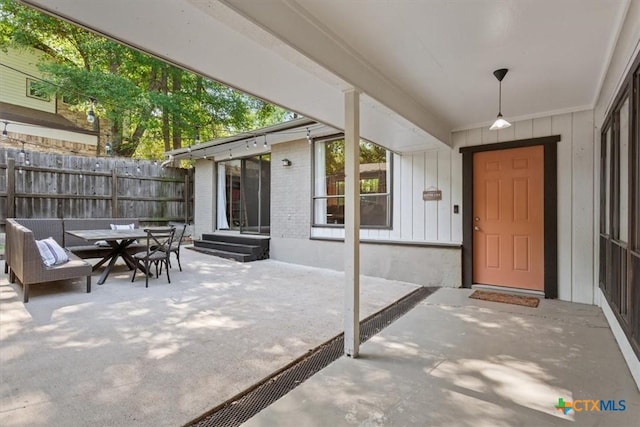 4005 Trailwood Dr, Temple, TX 76502 - entrance to property featuring fence, brick siding, a patio area, board and batten siding, and outdoor dining area