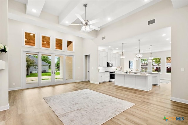 living room with recessed lighting, light wood-style floors, and visible vents