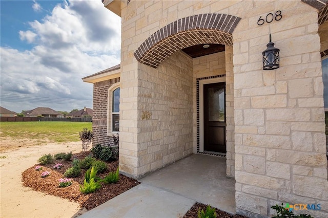 doorway to property featuring stone siding