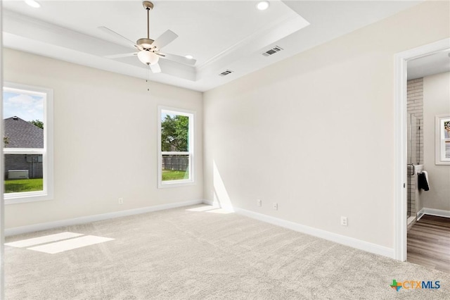 unfurnished room with recessed lighting, a tray ceiling, visible vents, and carpet floors