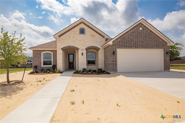 view of front of home with concrete driveway, stone siding, brick siding, and a garage