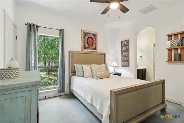 bedroom featuring concrete flooring, arched walkways, visible vents, and ceiling fan