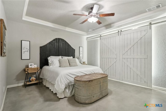 bedroom with a barn door, baseboards, crown molding, and visible vents
