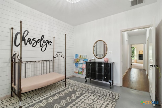 interior space featuring concrete flooring, visible vents, and baseboards