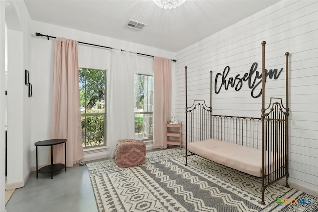 bedroom featuring visible vents and concrete floors
