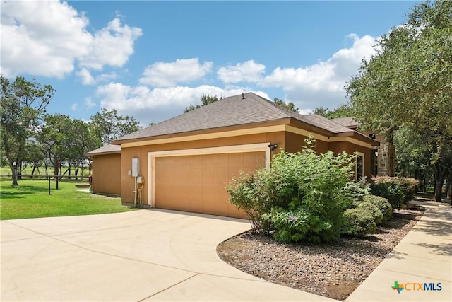 view of front of house featuring a garage, concrete driveway, a shingled roof, a front yard, and stucco siding